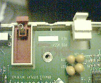 Photo of spring-loaded buttons that hold battery.